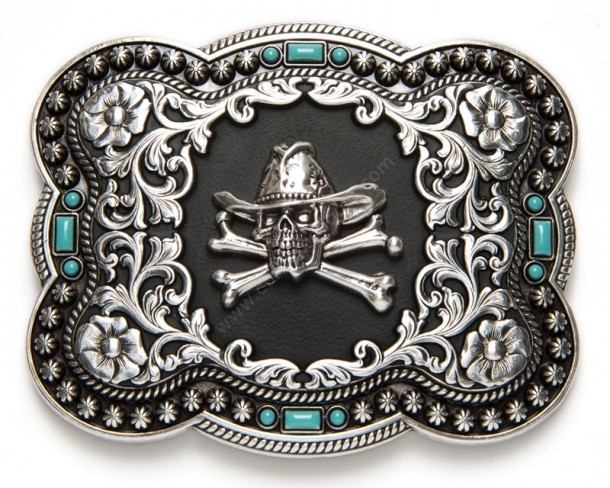 Buy at our western online shop this Nocona belt buckle with a skull with cowboy hay, floral filigrees in relief and little blue embedded stones.