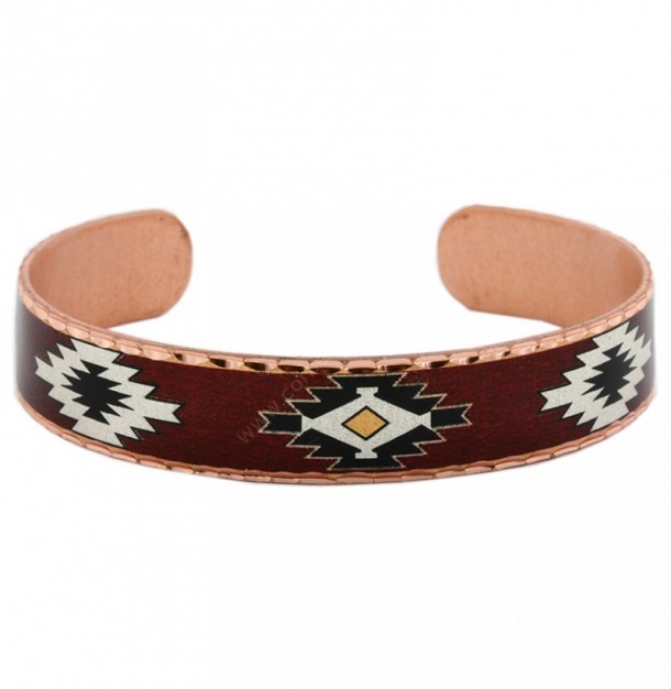 Southwestern handcrafted black & white inlay cuff bracelet over burgundy background