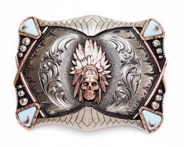 Feathered Aztec skull buckle with turquoise blue corners