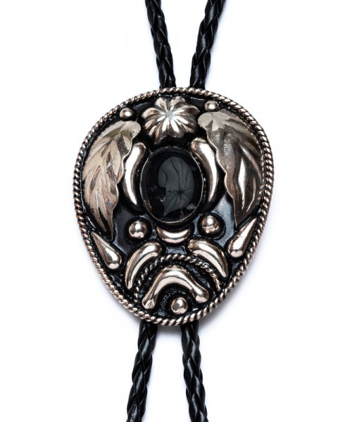 Handmade alpaca cowboy bolo tie with floral embossing and onyx-look stone inlay for sale at Corbeto